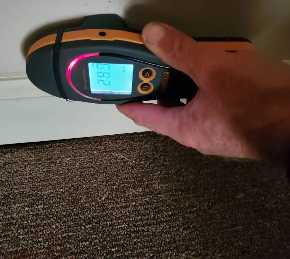 Moisture detection at baseboard during Storm Damage Restoration in Eidson Road